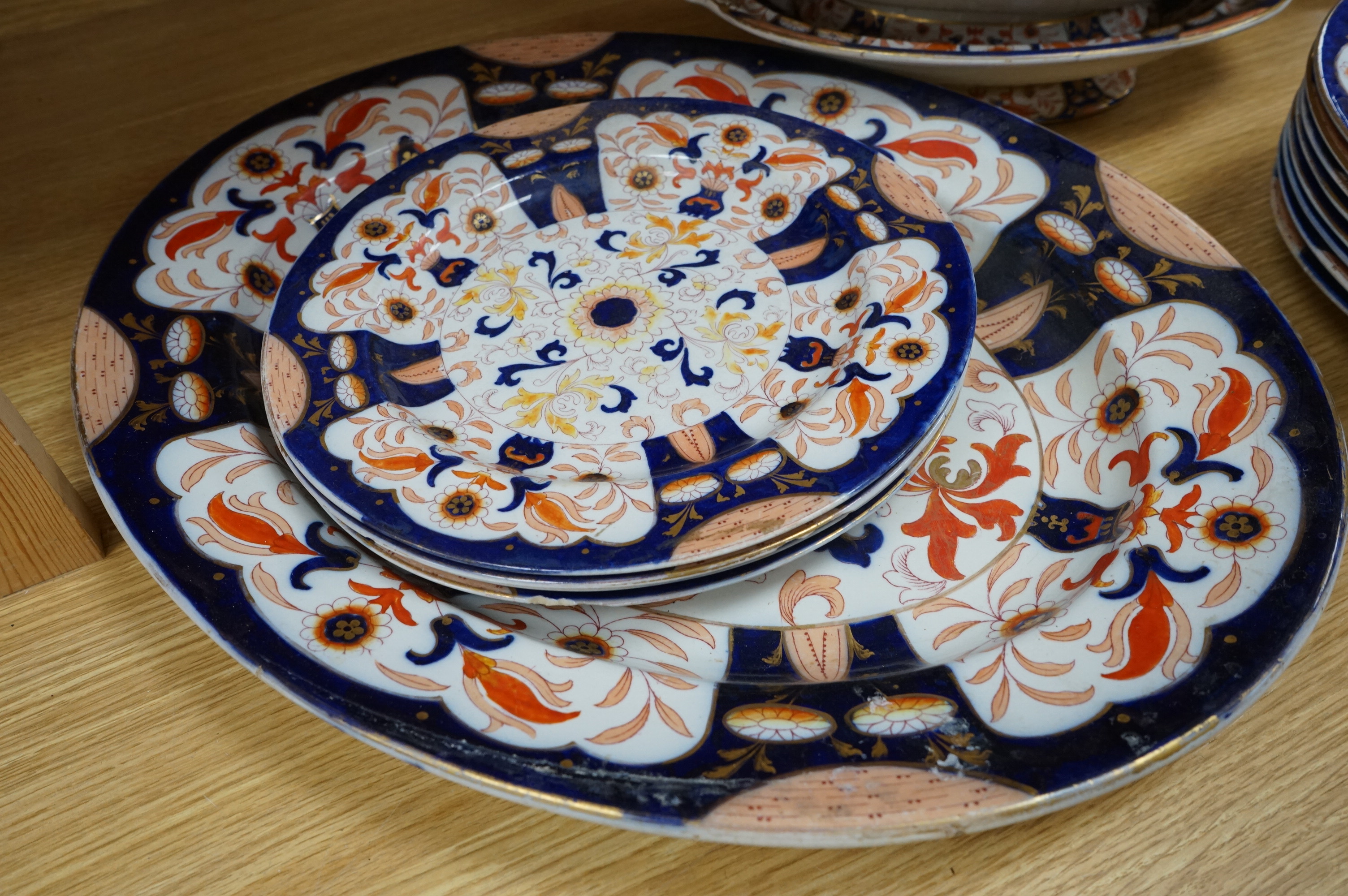 Fifteen items of a mid 19th century Mason's/Ashworth’s ironstone dinner service. Oval meat platter 48.5cm wide. Condition - three plates chipped, some losses to gilding